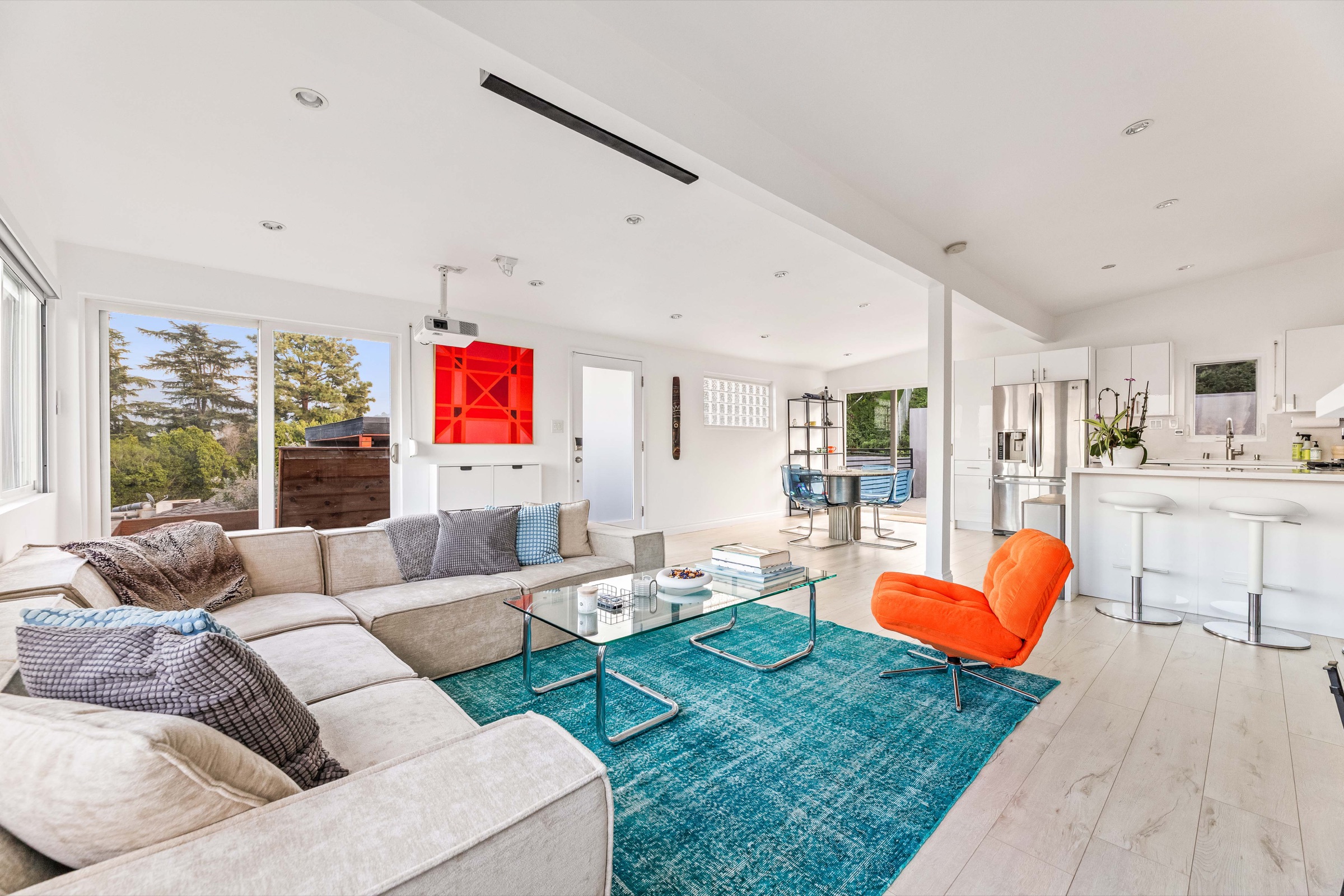 Open living space with wide windows overlooking Los Angeles